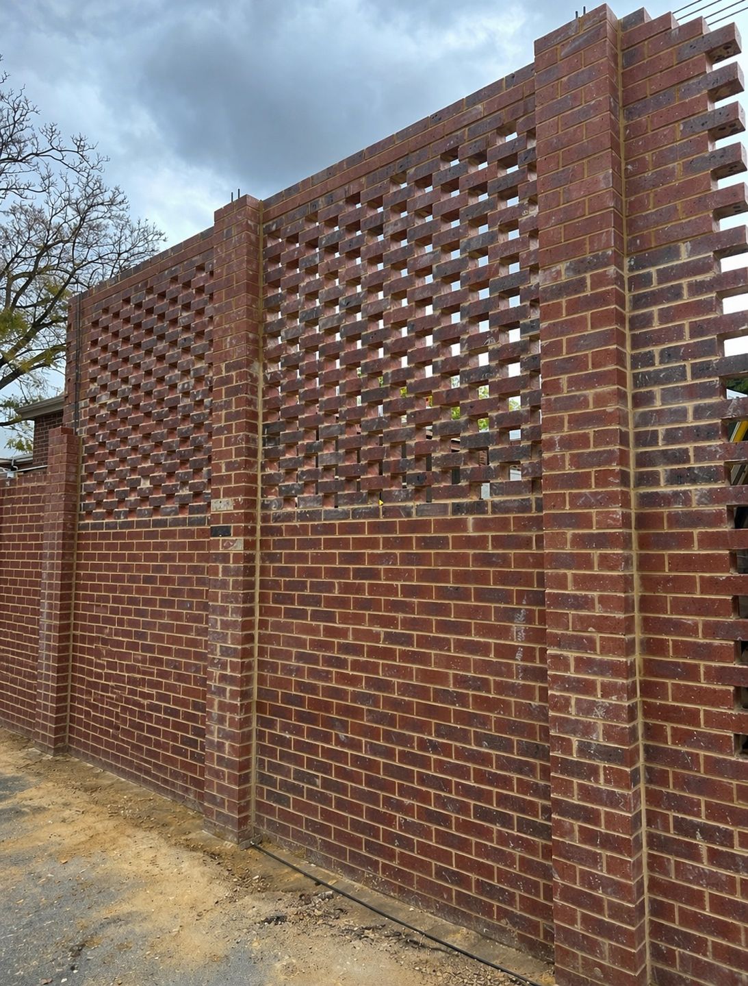 Hit-and-miss feature brick wall sitting atop a solid base course — Subiaco